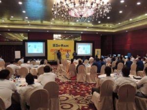 Su-Kam Manthan dealer conference hall with stage screens and packed tables