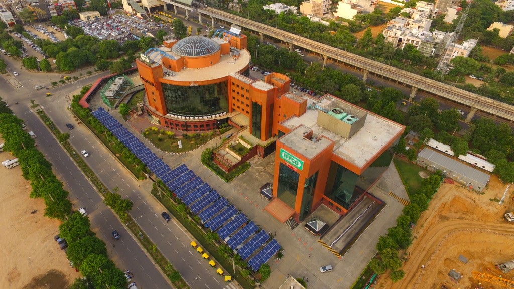 IFFCO Tower aerial with solar panels and urban Gurugram surroundings