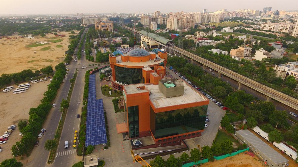 Aerial IFFCO Gurugram complex with solar array and elevated metro in background