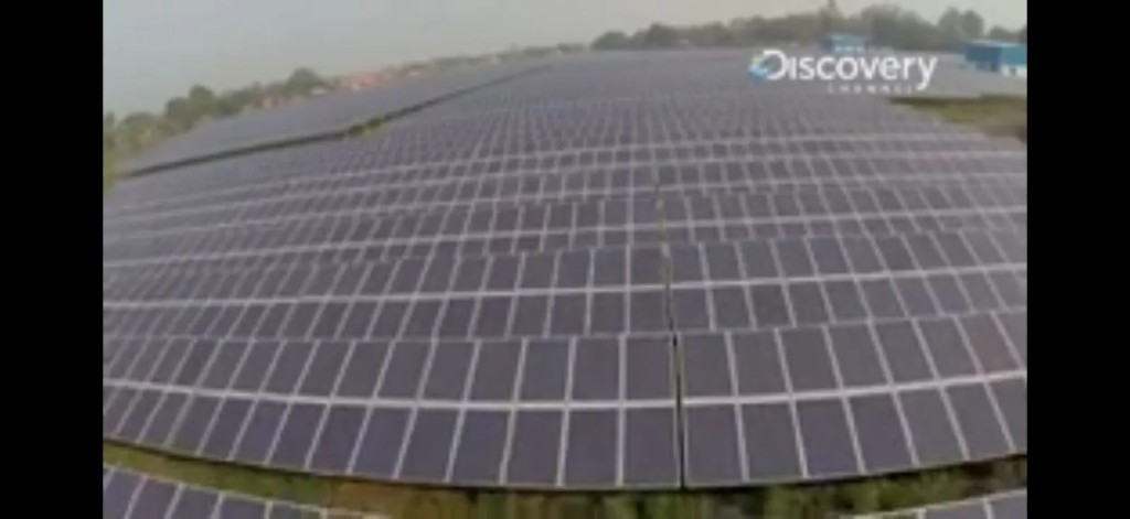 Discovery Channel Sun Fuel still — close aerial of dense rooftop solar panel arrays