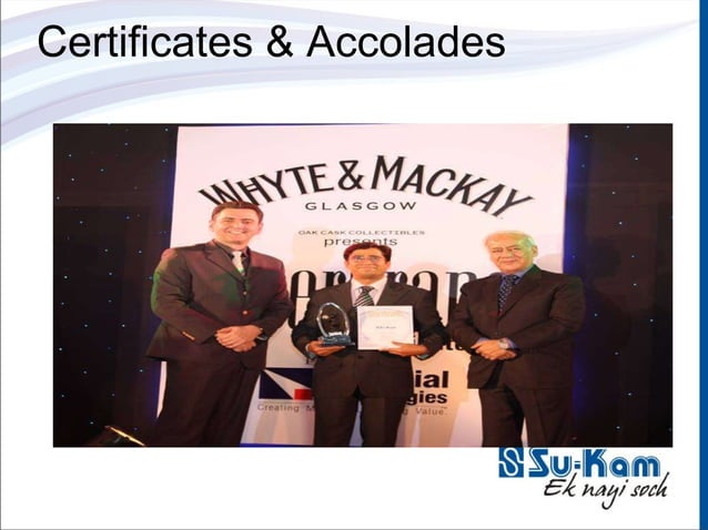 Kunwer Sachdev on stage at a Whyte and Mackay associated awards evening with trophy and certificate