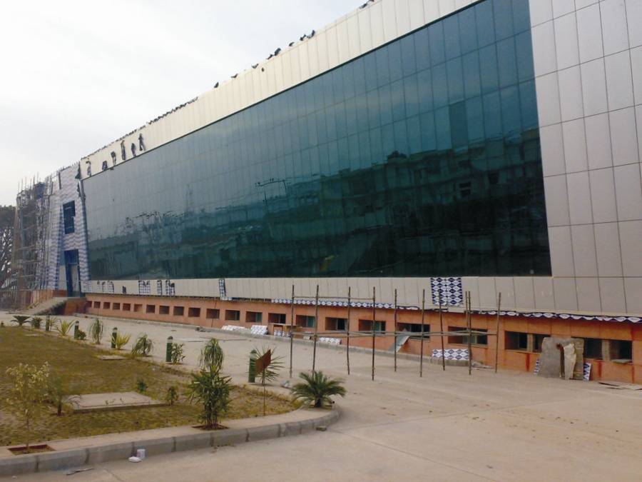 Baddi factory exterior from Su-Kam Corporate Focus Keynote — modern glass facade