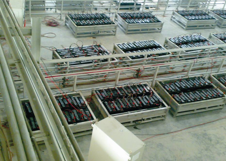 Baddi factory interior from Corporate Focus Keynote — battery racks and test wiring