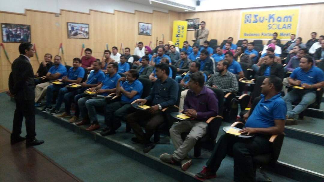 Channel partners seated in a training auditorium in Su-Kam Solar polos